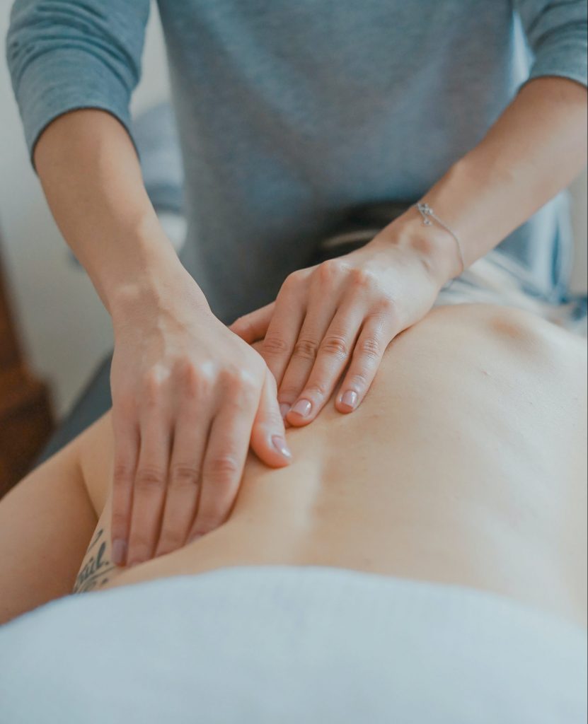 a masseuse working on a clients back